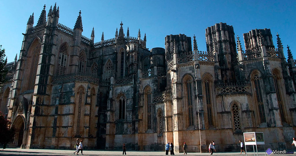 Sur la gauche, le portail du transept et à droite, les chapelles imparfaites, surmontées des immenses piliers inachevés.