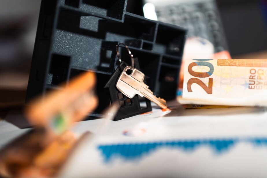 Des clés posées près d’un billet de 20 euros et d’un graphique.